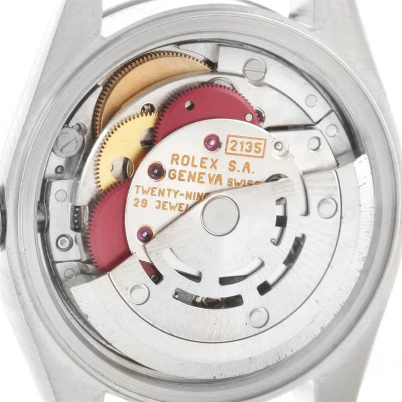 The image shows an angled view of the internal movement mechanism of a Rolex Datejust 69174 Women
s Stainless Steel Black Dial 69174 Women
s Stainless Steel Black Dial watch.