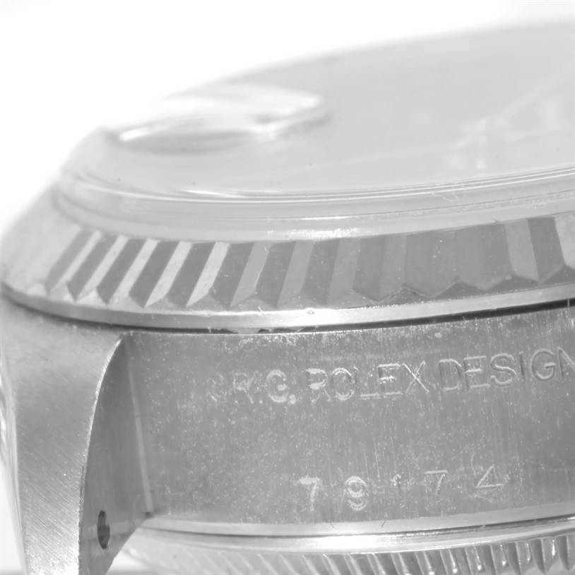 The image shows a close-up of the side of the case and the fluted bezel of a Rolex Datejust 79174 Women
s Stainless Steel Blue Dial 79174 Women
s Stainless Steel Blue Dial watch.