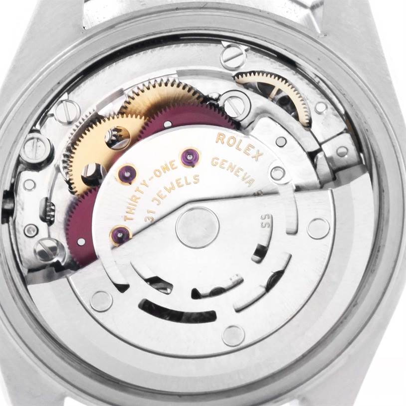 The image shows the internal mechanism of a Rolex Datejust 79174 Women
s Stainless Steel Blue Dial 79174 Women
s Stainless Steel Blue Dial watch, featuring gears and jewels, viewed from the back case.