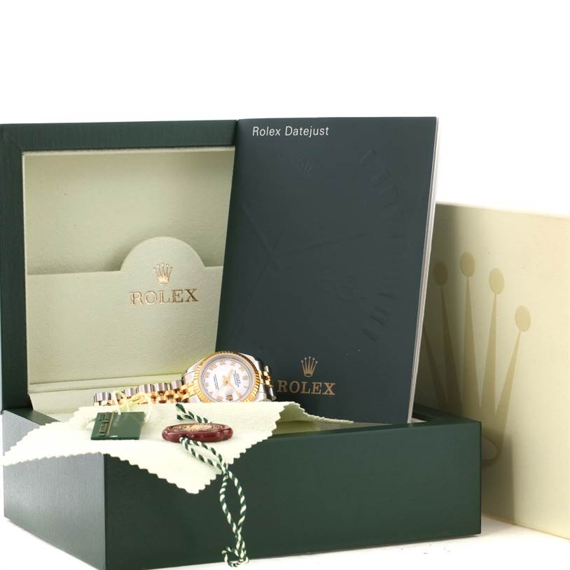 The image shows a Rolex Datejust 179173 Women's Steel and Gold (two tone) White Dial 179173 Women's Steel and Gold (two tone) White Dial watch with accessories, including the original box, booklet, and tags, viewed from the side angle.