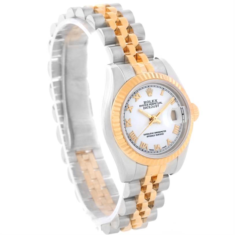 The image shows the face and part of the strap of a Rolex Datejust 179173 Women's Steel and Gold (two tone) White Dial 179173 Women's Steel and Gold (two tone) White Dial watch, angled from the lower left side.