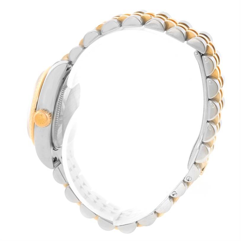 This side view of the Rolex Datejust 179173 Women's Steel and Gold (two tone) White Dial 179173 Women's Steel and Gold (two tone) White Dial watch shows the crown and bracelet, featuring a gold and silver two-tone design.