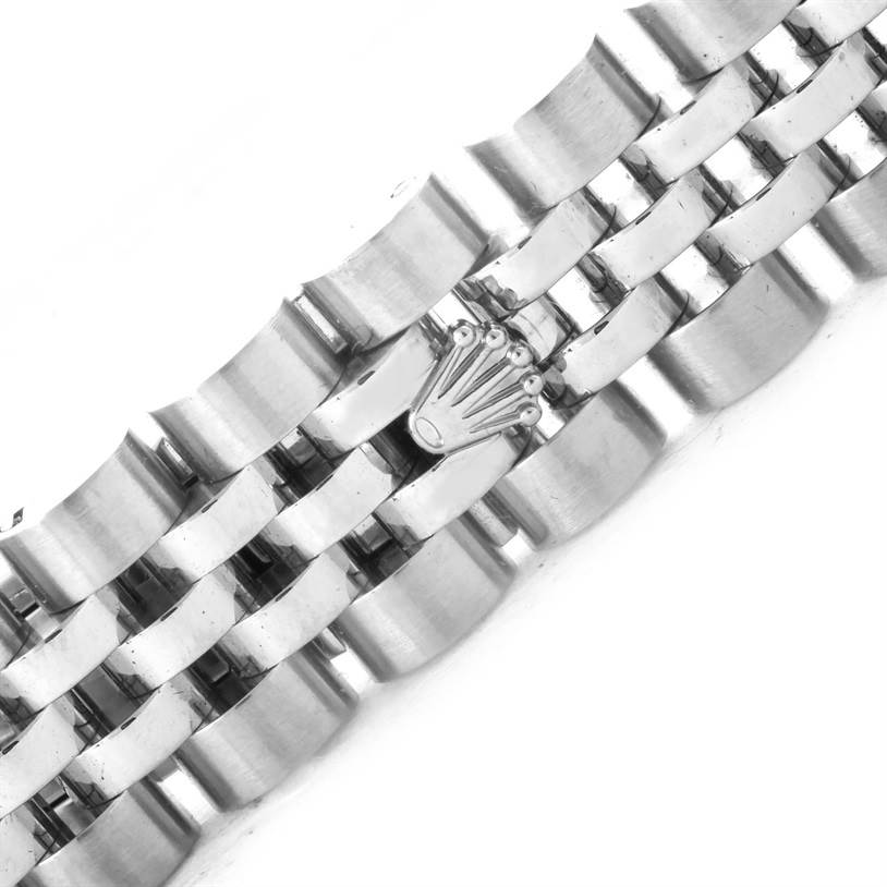 The image shows a close-up of the bracelet of a Rolex Datejust 179174 Women
s Stainless Steel Mother of Pearl Dial 179174 Women
s Stainless Steel Mother of Pearl Dial watch, highlighting the clasp with the Rolex crown logo.