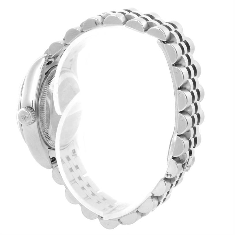 The image shows a side view of a Rolex Datejust 179174 Women
s Stainless Steel Mother of Pearl Dial 179174 Women
s Stainless Steel Mother of Pearl Dial watch, highlighting its case, crown, and metal bracelet.