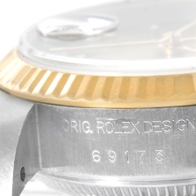 This close-up shot of the Rolex Datejust 69173 Women's Stainless Steel Champagne Dial 69173 Women's Stainless Steel Champagne Dial watch shows the side of the bezel and the engraved model number on the case.