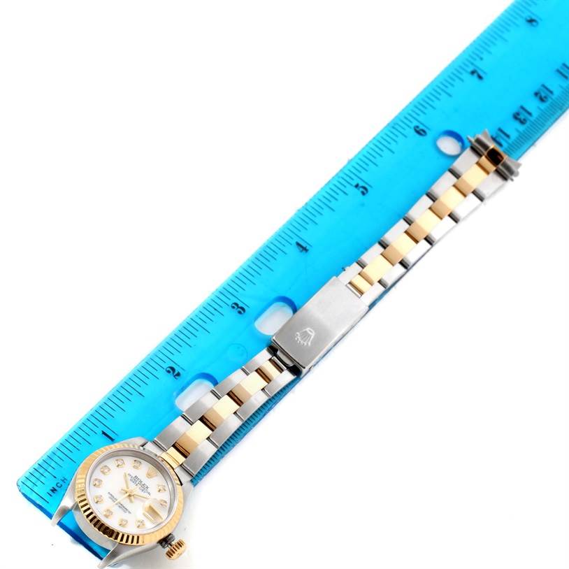 The image shows an overhead view of a Rolex Datejust 69173 Women's Stainless Steel Mother of Pearl Dial 69173 Women's Stainless Steel Mother of Pearl Dial watch next to a ruler, highlighting its bracelet and clasp.