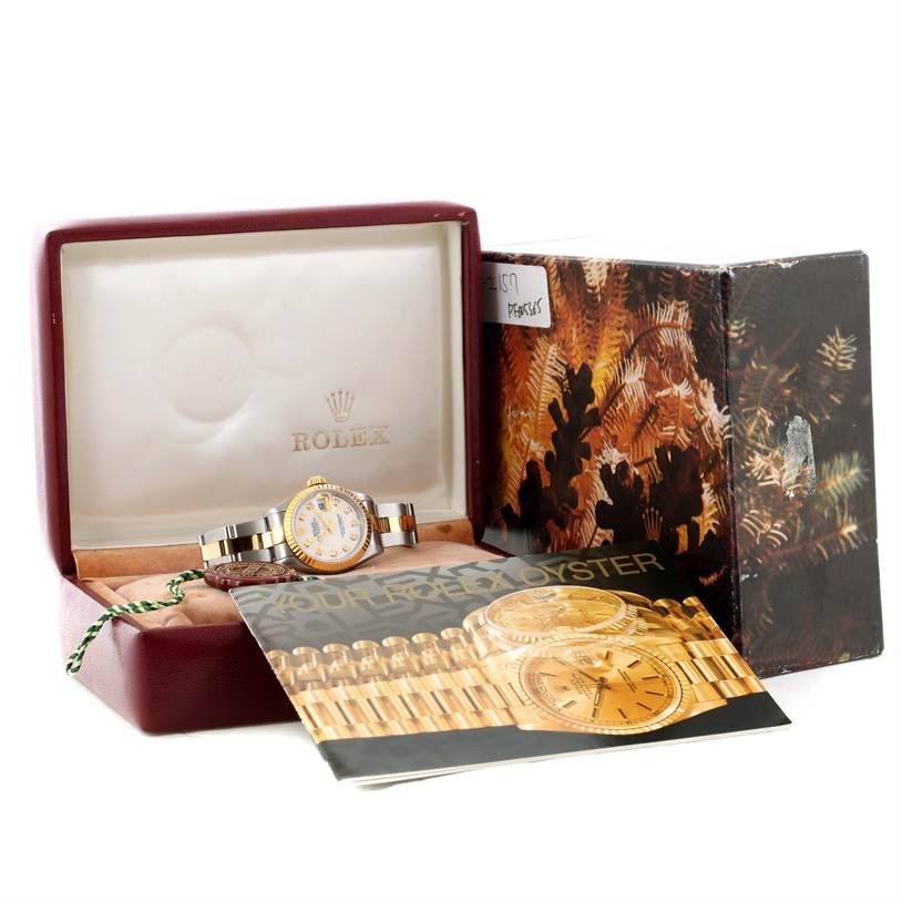 The Rolex Datejust 69173 Women's Stainless Steel Mother of Pearl Dial 69173 Women's Stainless Steel Mother of Pearl Dial watch is shown in its open box with a booklet and outer packaging visible.