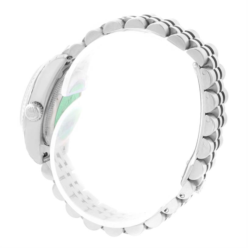 This side view of the Rolex Datejust 179174 Women's Stainless Steel White Dial 179174 Women's Stainless Steel White Dial watch model showcases its crown and part of the metal bracelet.