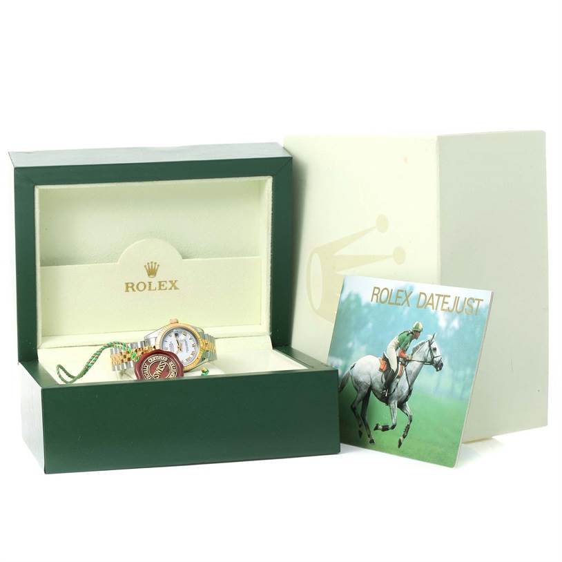 The image shows a Rolex Datejust 179173 Women's Steel and Gold (two tone) White Dial 179173 Women's Steel and Gold (two tone) White Dial watch inside its open box, alongside a booklet and the outer packaging.
