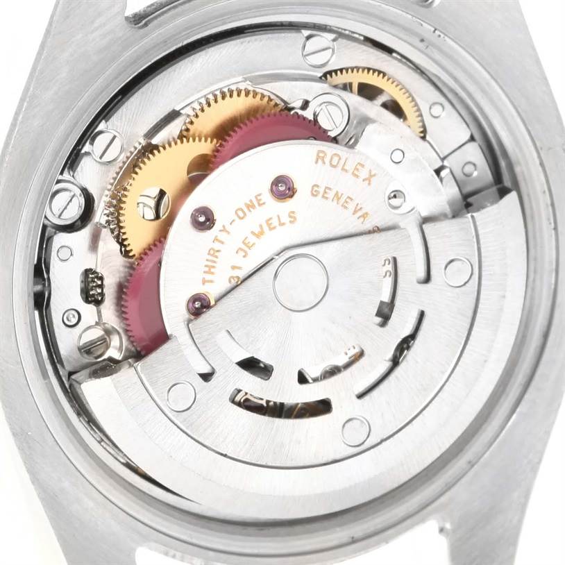 The image displays the intricate movement of a Rolex Datejust 179173 Women's Steel and Gold (two tone) White Dial 179173 Women's Steel and Gold (two tone) White Dial watch from the back case view.