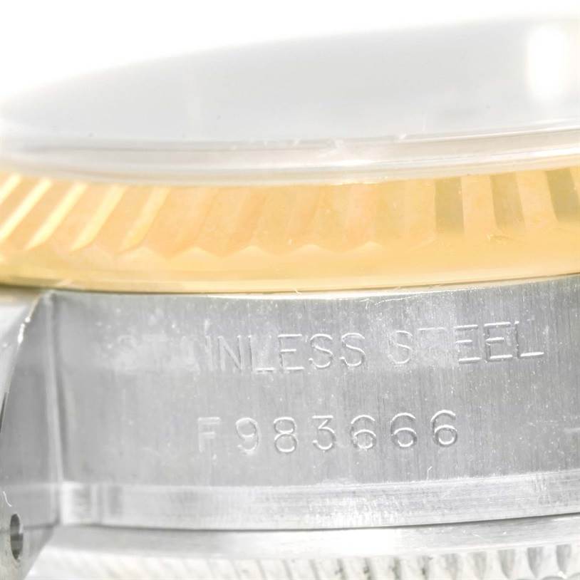 The image shows a close-up angle of the Rolex Datejust 179173 Women's Steel and Gold (two tone) White Dial 179173 Women's Steel and Gold (two tone) White Dial, focusing on the stainless steel case and part of the fluted bezel.
