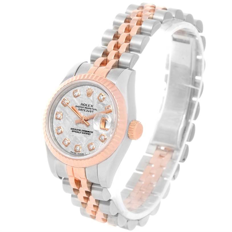 This image shows a Rolex Datejust 179171 Women
s Steel and Gold (two tone) Silver Dial 179171 Women
s Steel and Gold (two tone) Silver Dial watch at an angle, featuring a two-tone band and a diamond-studded dial.