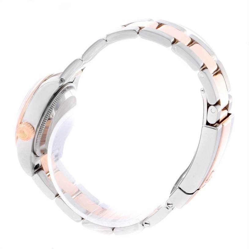 The Rolex Datejust 179161PDO Women's Steel and Gold (two tone) Pink Dial 179161PDO Women's Steel and Gold (two tone) Pink Dial watch is shown from a side angle, highlighting the bracelet, crown, and case.
