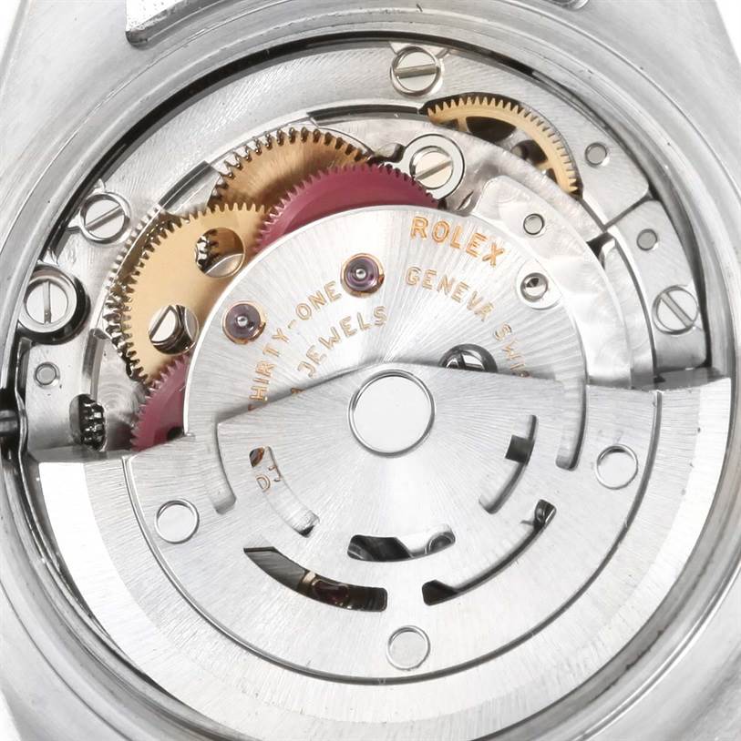 This image shows the internal mechanism of a Rolex Datejust 179161PDO Women's Steel and Gold (two tone) Pink Dial 179161PDO Women's Steel and Gold (two tone) Pink Dial watch, highlighting its gears and rotor.