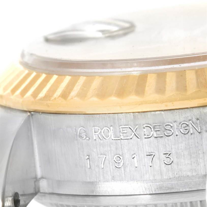 This image shows a close-up angle of the side of a Rolex Datejust 179173 Women's Steel and Gold (two tone) Black Dial 179173 Women's Steel and Gold (two tone) Black Dial watch, focusing on the case and markings.