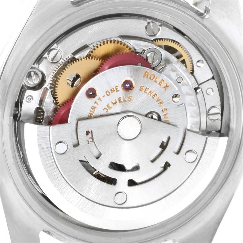 This image shows a close-up of the movement mechanism of a Rolex Datejust 179173 Women's Steel and Gold (two tone) Black Dial 179173 Women's Steel and Gold (two tone) Black Dial watch, highlighting intricate gears and components.