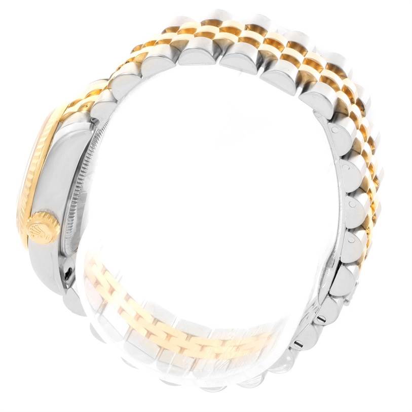 The image shows a side view of a Rolex Datejust 179173 Women's Steel and Gold (two tone) Black Dial 179173 Women's Steel and Gold (two tone) Black Dial watch, focusing on its two-tone bracelet and partially visible crown.