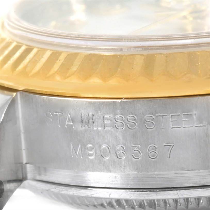 This close-up image shows the case side and part of the bezel of a Rolex Datejust 179173 Women's Steel and Gold (two tone) Black Dial 179173 Women's Steel and Gold (two tone) Black Dial model, highlighting the stainless steel material and serial number.