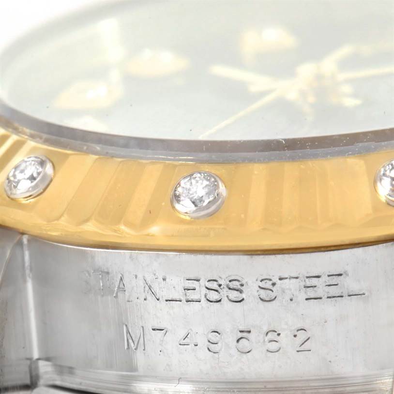 The image shows a close-up of the Rolex Datejust 179313 Women
s Stainless Steel Champagne Dial 179313 Women
s Stainless Steel Champagne Dial watch’s bezel and part of the case, highlighting diamonds and stainless steel.