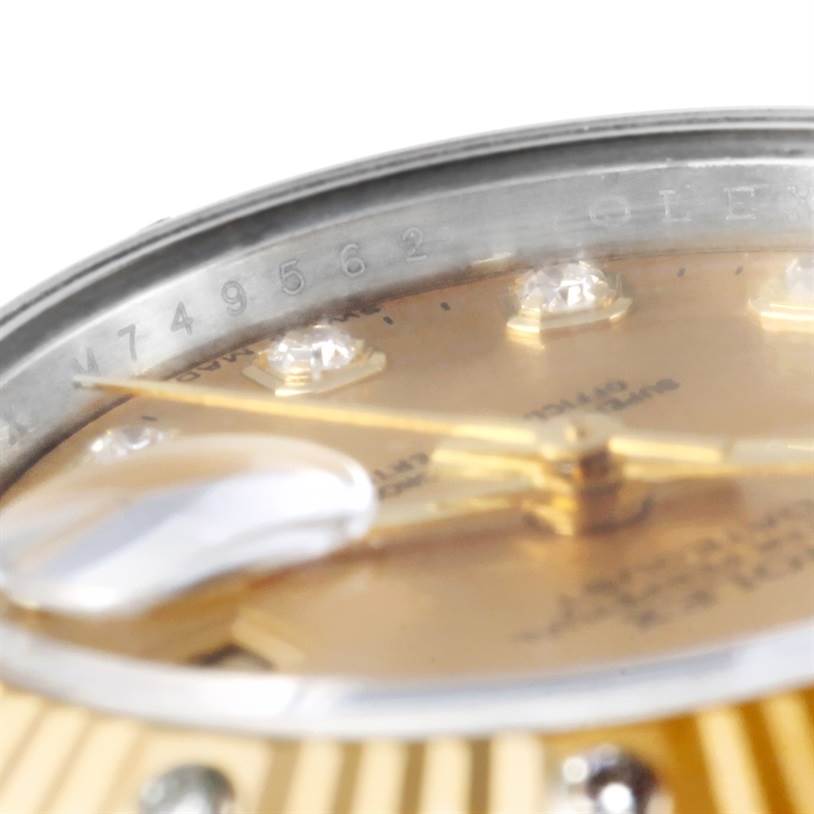 The image shows a close-up of the Rolex Datejust 179313 Women
s Stainless Steel Champagne Dial 179313 Women
s Stainless Steel Champagne Dial watch dial, hands, diamond hour markers, and part of the fluted bezel.