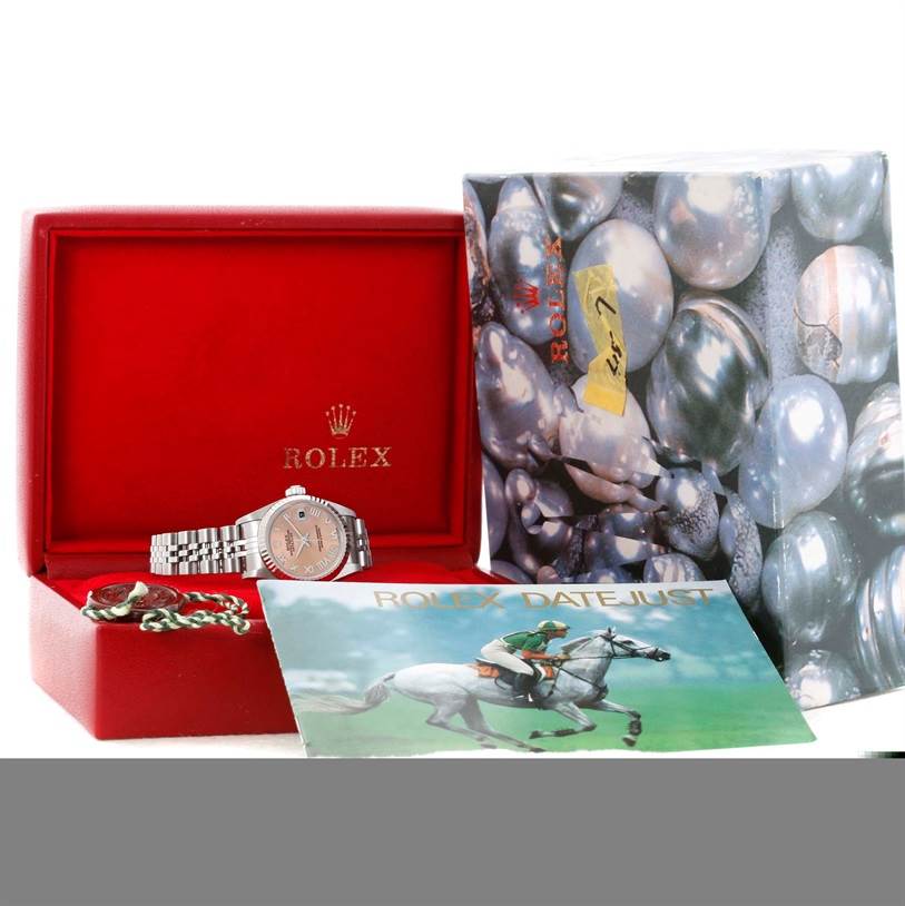 This image shows a Rolex Datejust 79174 Women's Stainless Steel Pink Dial 79174 Women's Stainless Steel Pink Dial watch with its box, manual, and packaging viewed from the front.