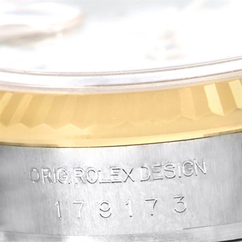 The image shows a close-up of the side of a Rolex Datejust 179173 Women's Steel and Gold (two tone) White Dial 179173 Women's Steel and Gold (two tone) White Dial model, highlighting the bezel and engraved model number.