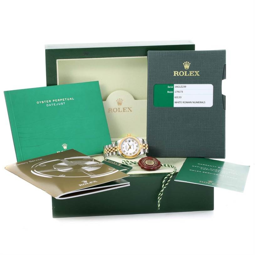The image shows a Rolex Datejust 179173 Women's Steel and Gold (two tone) White Dial 179173 Women's Steel and Gold (two tone) White Dial watch with its box, warranty card, manuals, and accessories from a frontal angle.