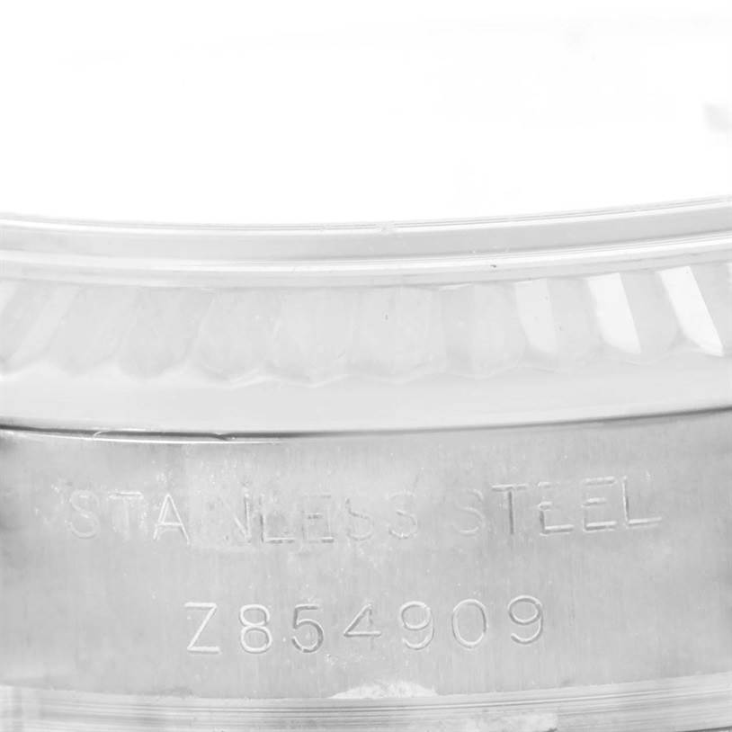 This close-up image shows the case back and part of the bezel of a Rolex Datejust 179174 Women
s Stainless Steel Mother of Pearl Dial 179174 Women
s Stainless Steel Mother of Pearl Dial watch with stainless steel and the serial number.