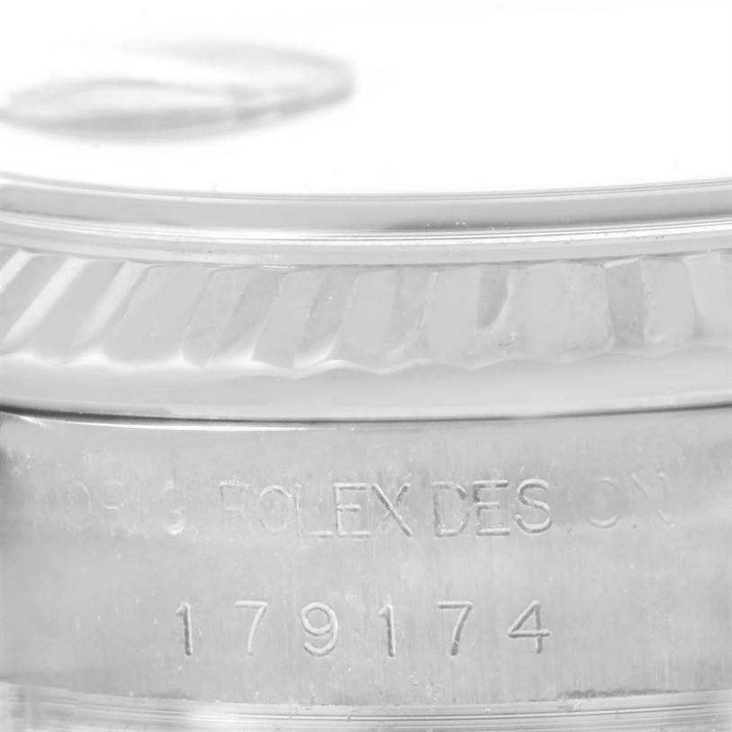 The image shows a close-up of the outer edge and engraved serial number of a Rolex Datejust 179174 Women
s Stainless Steel Mother of Pearl Dial 179174 Women
s Stainless Steel Mother of Pearl Dial watch.