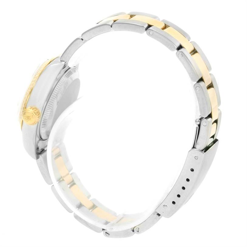 The image shows the side view of a Rolex Datejust 79173 Women
s Stainless Steel White Dial 79173 Women
s Stainless Steel White Dial watch, emphasizing the two-tone bracelet and the crown.