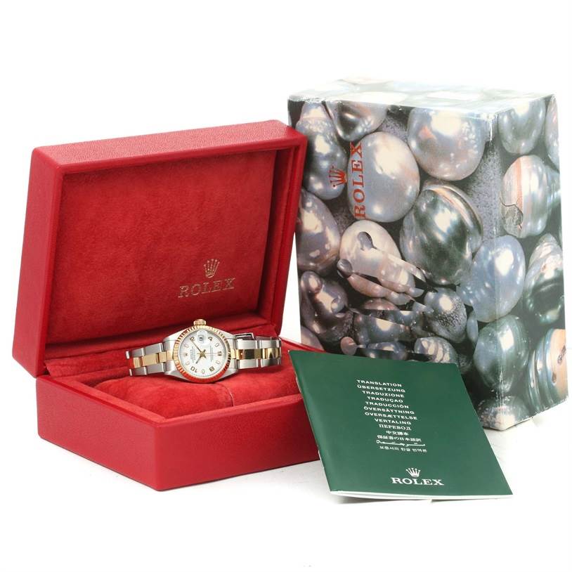 A Rolex Datejust 79173 Women
s Stainless Steel White Dial 79173 Women
s Stainless Steel White Dial watch is displayed in an open red box with an accompanying booklet and branded outer box.
