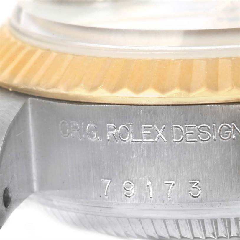 The image shows a close-up of the side view of a Rolex Datejust 79173 Women
s Stainless Steel White Dial 79173 Women
s Stainless Steel White Dial watch case, highlighting the model number and part of the bezel.