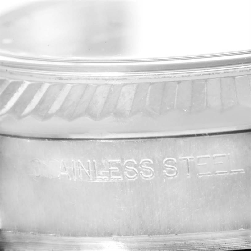 The image shows a close-up of the stainless steel case and fluted bezel of a Rolex Datejust 179174 Women's Stainless Steel Black Dial 179174 Women's Stainless Steel Black Dial watch.