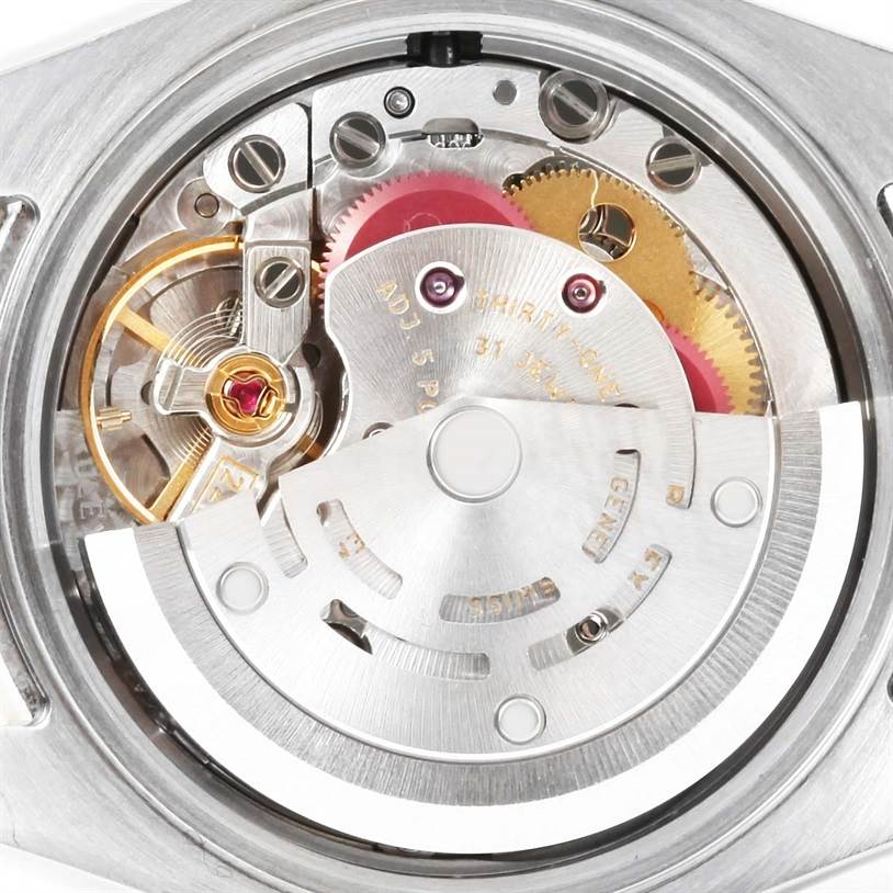 This image shows a close-up of the inner mechanism of a Rolex Datejust 179173 Women's Steel and Gold (two tone) Silver Dial 179173 Women's Steel and Gold (two tone) Silver Dial watch, highlighting the movement and gears.