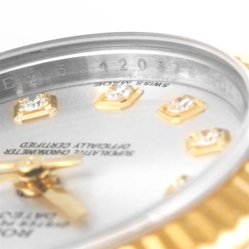 The image shows a close-up of the Rolex Datejust 179173 Women's Steel and Gold (two tone) Silver Dial 179173 Women's Steel and Gold (two tone) Silver Dial model, focusing on the dial with diamond hour markers and part of the serial number.