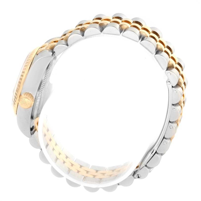 The image shows a side view of the Rolex Datejust 179173 Women's Steel and Gold (two tone) Silver Dial 179173 Women's Steel and Gold (two tone) Silver Dial watch, illustrating the gold and silver bracelet and the crown.