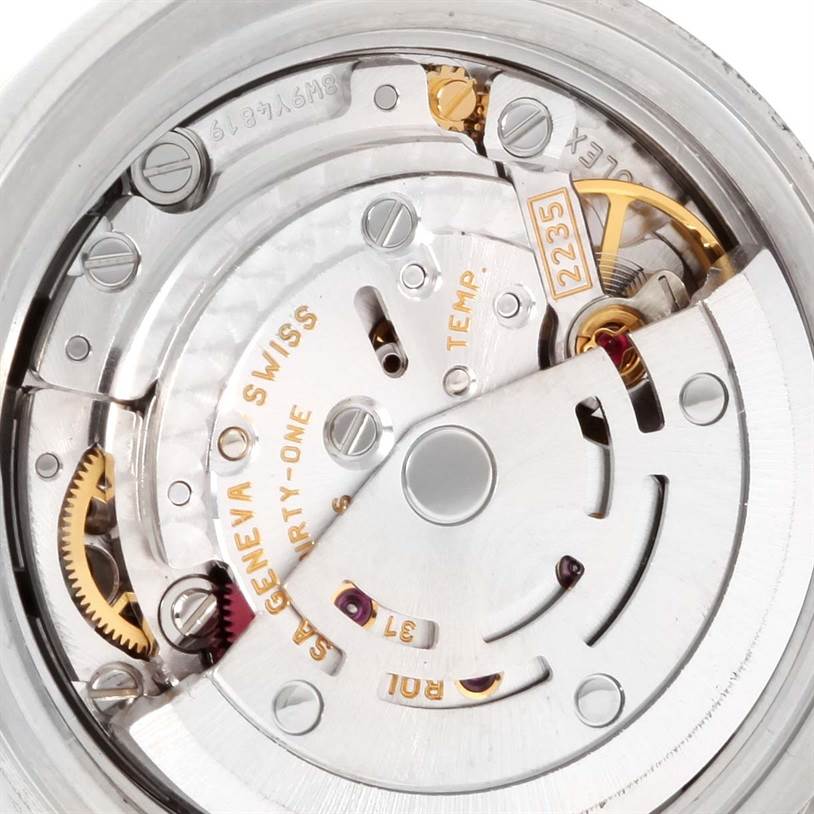 This image shows a close-up of the Rolex Datejust 179173SDO Women's Steel and Gold (two tone) Silver Dial 179173SDO Women's Steel and Gold (two tone) Silver Dial movement mechanism from the back, highlighting gears and the rotor.