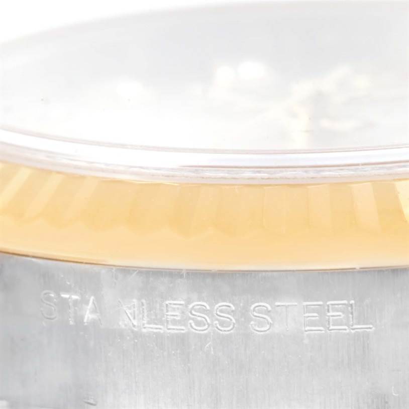 This image shows a close-up of the stainless steel case and the fluted bezel of a Rolex Datejust 179173SDO Women's Steel and Gold (two tone) Silver Dial 179173SDO Women's Steel and Gold (two tone) Silver Dial watch.