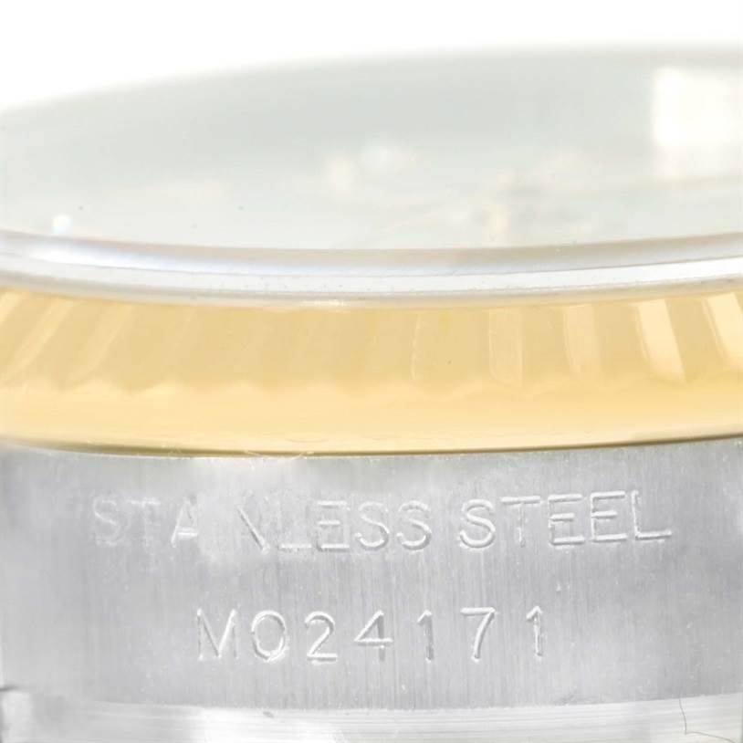 The image shows a close-up of the side view of the stainless steel casing and fluted bezel of a Rolex Datejust 179173 Women's Steel and Gold (two tone) Mother of Pearl Dial 179173 Women's Steel and Gold (two tone) Mother of Pearl Dial watch with model number engraved.