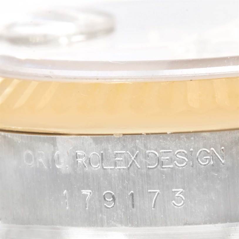 This close-up shows the side view of the Rolex Datejust 179173 Women's Steel and Gold (two tone) Mother of Pearl Dial 179173 Women's Steel and Gold (two tone) Mother of Pearl Dial model, focusing on the "Orig. Rolex Design" engraving and the model number.