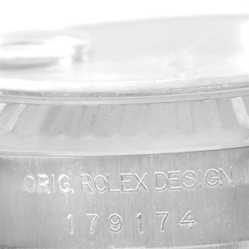 This close-up angle shows the serial number and "ORIG. ROLEX DESIGN" engraving on the Rolex Datejust 179174 Women's Stainless Steel White Dial 179174 Women's Stainless Steel White Dial model.