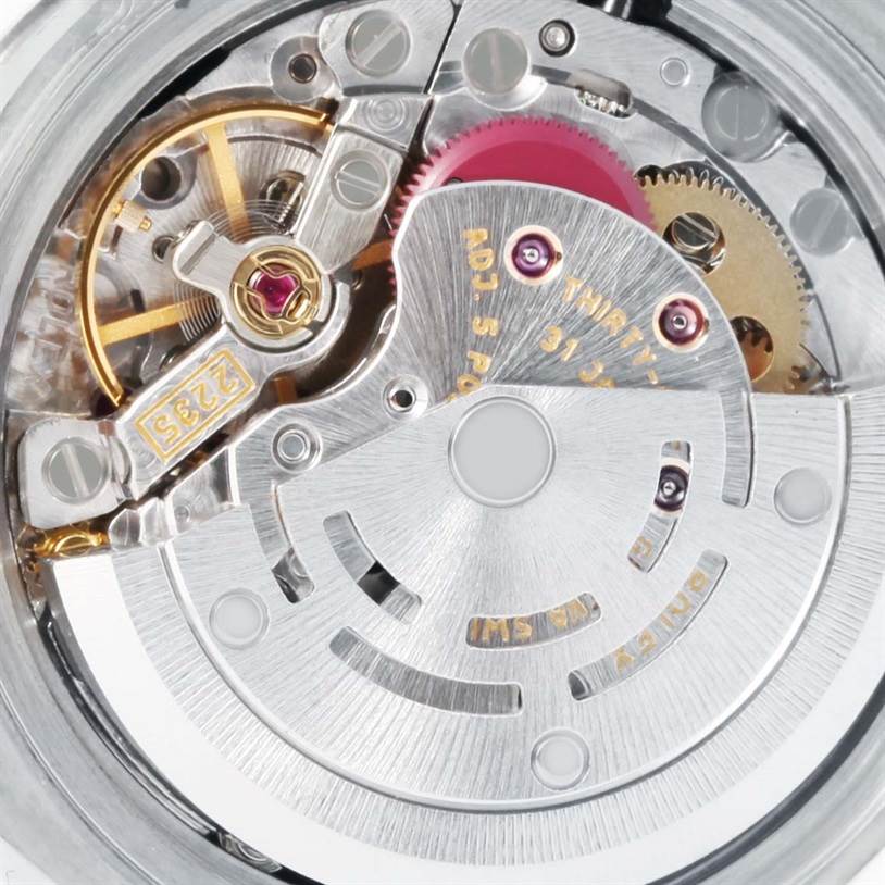 This image shows a close-up view of the Rolex Datejust 179174 Women
s Stainless Steel Black Dial 179174 Women
s Stainless Steel Black Dial movement mechanism, highlighting gears and the rotor.