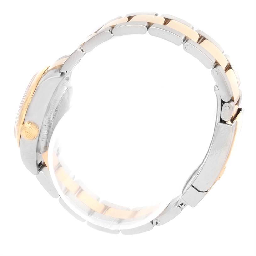 This side view of the Rolex Datejust 179163 Women's Steel and Gold (two tone) Silver Dial 179163 Women's Steel and Gold (two tone) Silver Dial watch displays the crown and part of the bracelet.