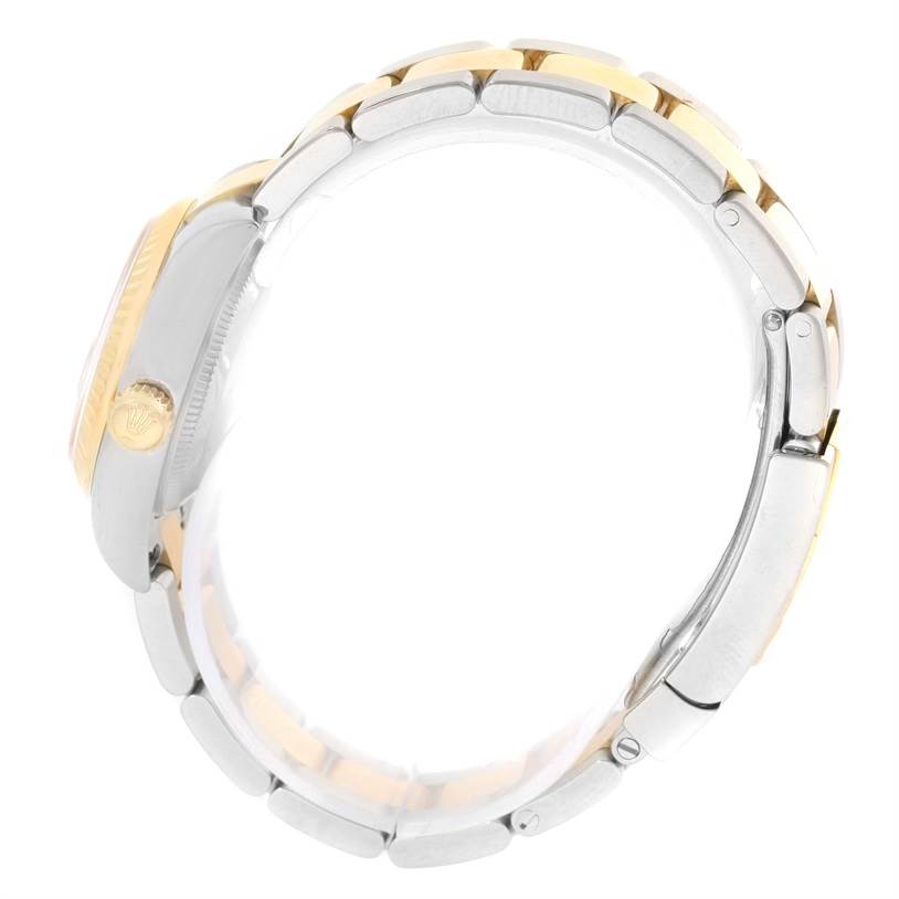 The side view of the Rolex Datejust 179173 Women's Steel and Gold (two tone) Silver Dial 179173 Women's Steel and Gold (two tone) Silver Dial watch shows the crown and the two-tone metal bracelet.