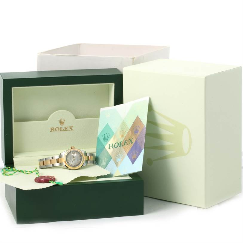 The image shows a Rolex Datejust 179173 Women's Steel and Gold (two tone) Silver Dial 179173 Women's Steel and Gold (two tone) Silver Dial watch and its accessories, including the box, booklets, hang tag, and warranty card.