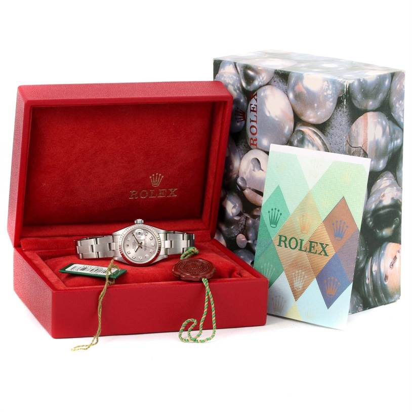 The image shows a Rolex Datejust 79174 Women's Stainless Steel Grey Dial 79174 Women's Stainless Steel Grey Dial watch in a red box with tags and a certificate, along with the outer box in the background.