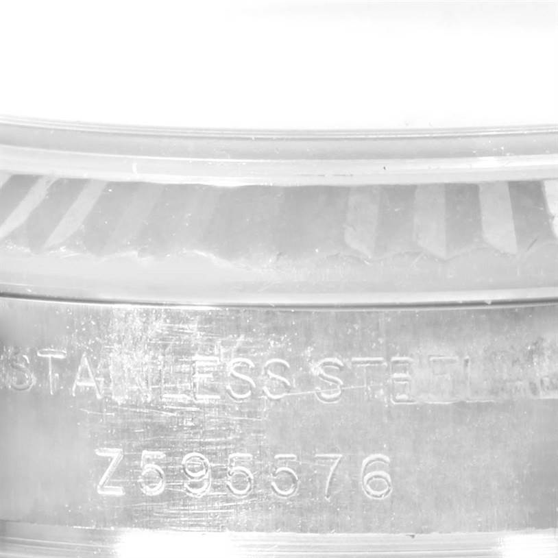 The image shows a close-up of the side of a Rolex Datejust 179174 Women's Stainless Steel Mother of Pearl Dial 179174 Women's Stainless Steel Mother of Pearl Dial watch case with engraved serial and model numbers.