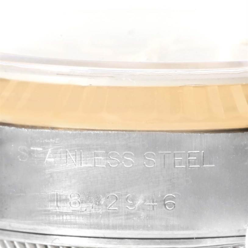 The image shows a close-up of the side of a Rolex Datejust 69173 Women
s Stainless Steel Champagne Dial 69173 Women
s Stainless Steel Champagne Dial watch, highlighting the stainless steel casing and serial number.