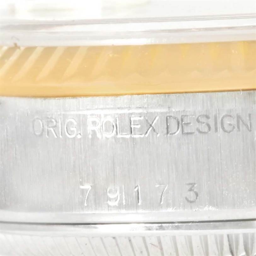This image shows a close-up view of the case side of a Rolex Datejust 79173 Women
s Stainless Steel Champagne Dial 79173 Women
s Stainless Steel Champagne Dial watch, highlighting the model number and "ORIG. ROLEX DESIGN" engraving.