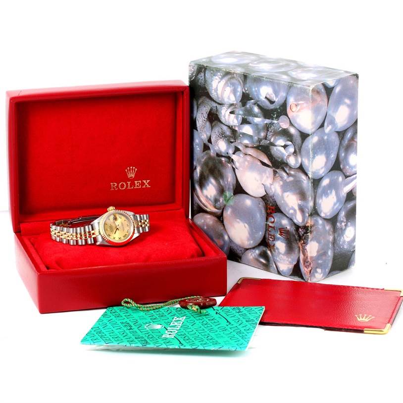 A Rolex Datejust 79173 Women
s Stainless Steel Champagne Dial 79173 Women
s Stainless Steel Champagne Dial watch is shown inside an open red case, alongside its outer box, tag, and paperwork.